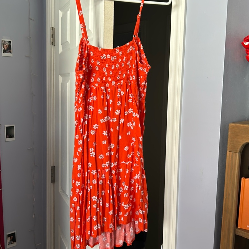 Orange dress with flowers 
Shorter end 
Could be a shirt or a dress 
Summer